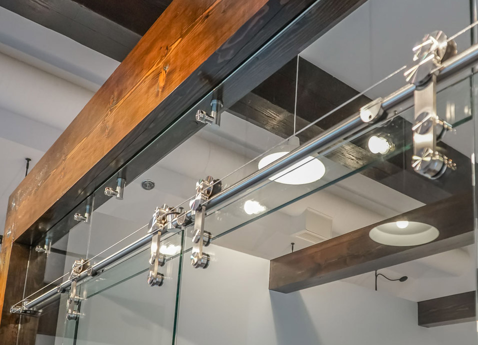 Glass door with stainless steel sliding hardware built by Timberlake Hardware - a Vancouver Island Hardware supply company. 