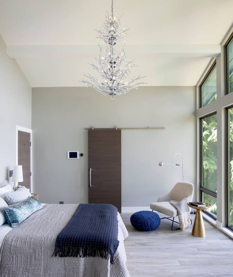 bright airy bedroom featuring a luxury barn door kit
