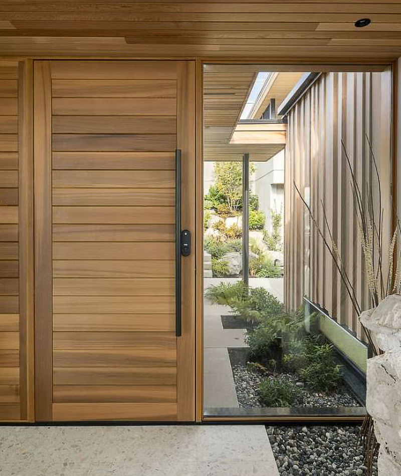 wood front entrance with white stone pathway, extra large window and black archetectural door pull 