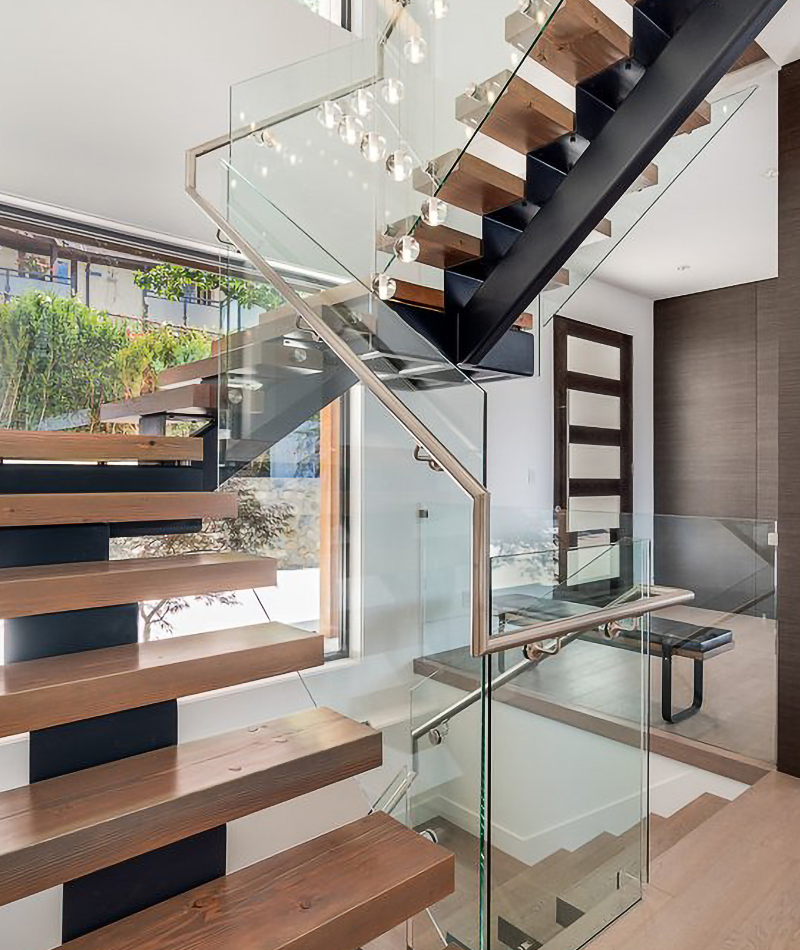 bright home with floating wood steps and framless glass railings 